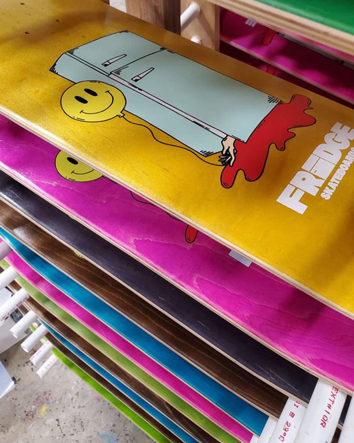 Colorful Free Edge skateboard decks stacked together as a recreation-focused accessory product