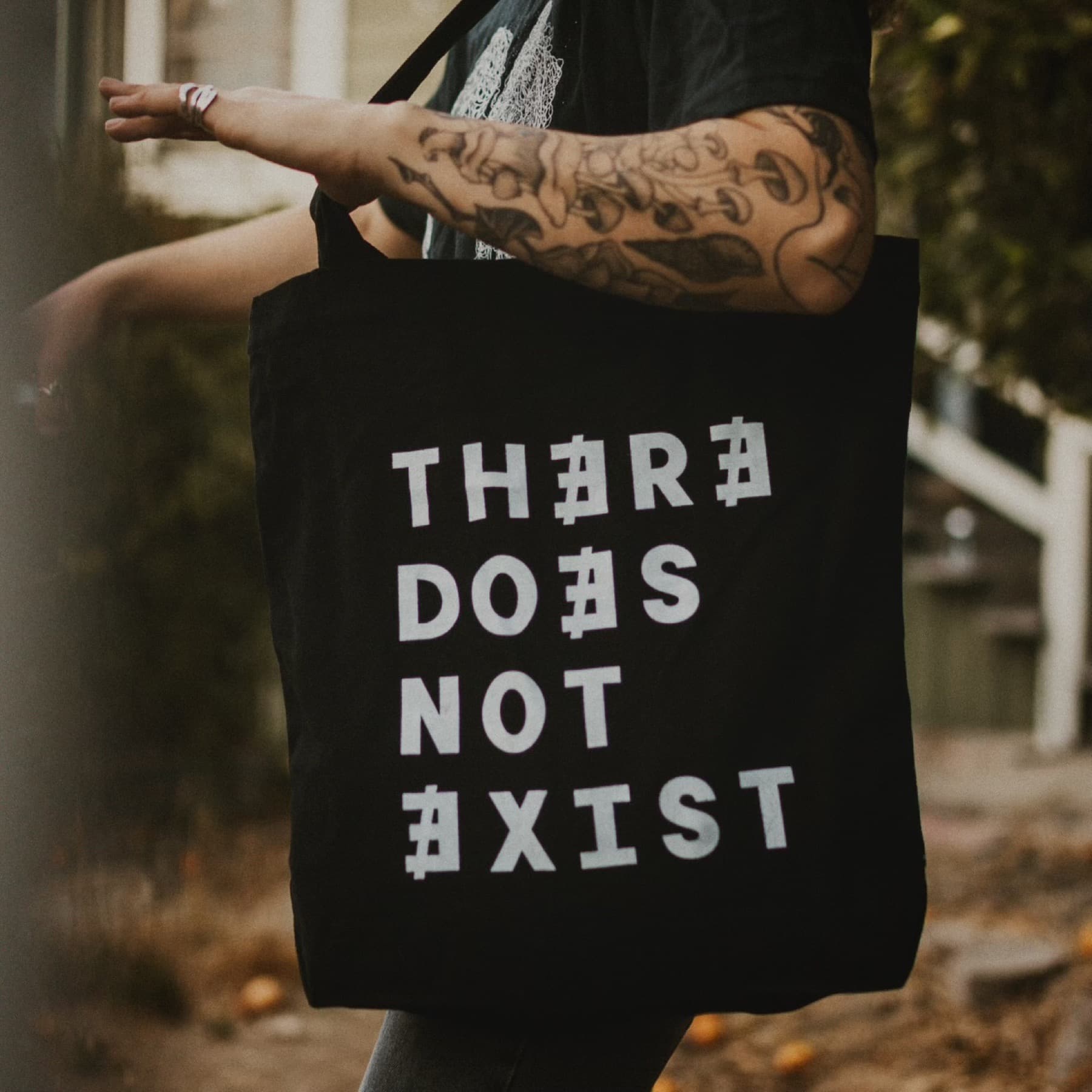 Black There Does Not Exist Brewery tote bag carried on shoulder