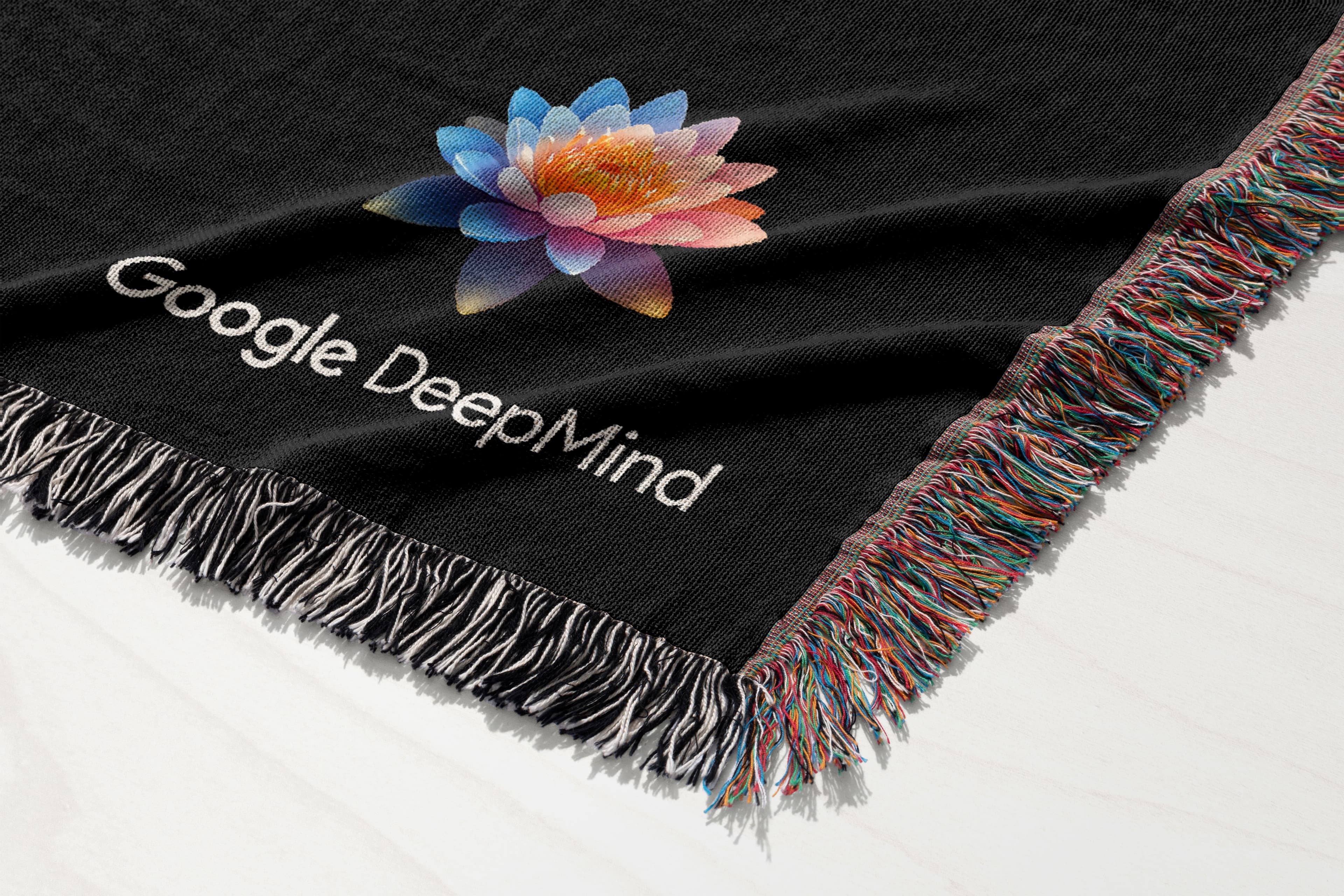 Google DeepMind woven blanket mockup shown with black textile and multicolor fringe
