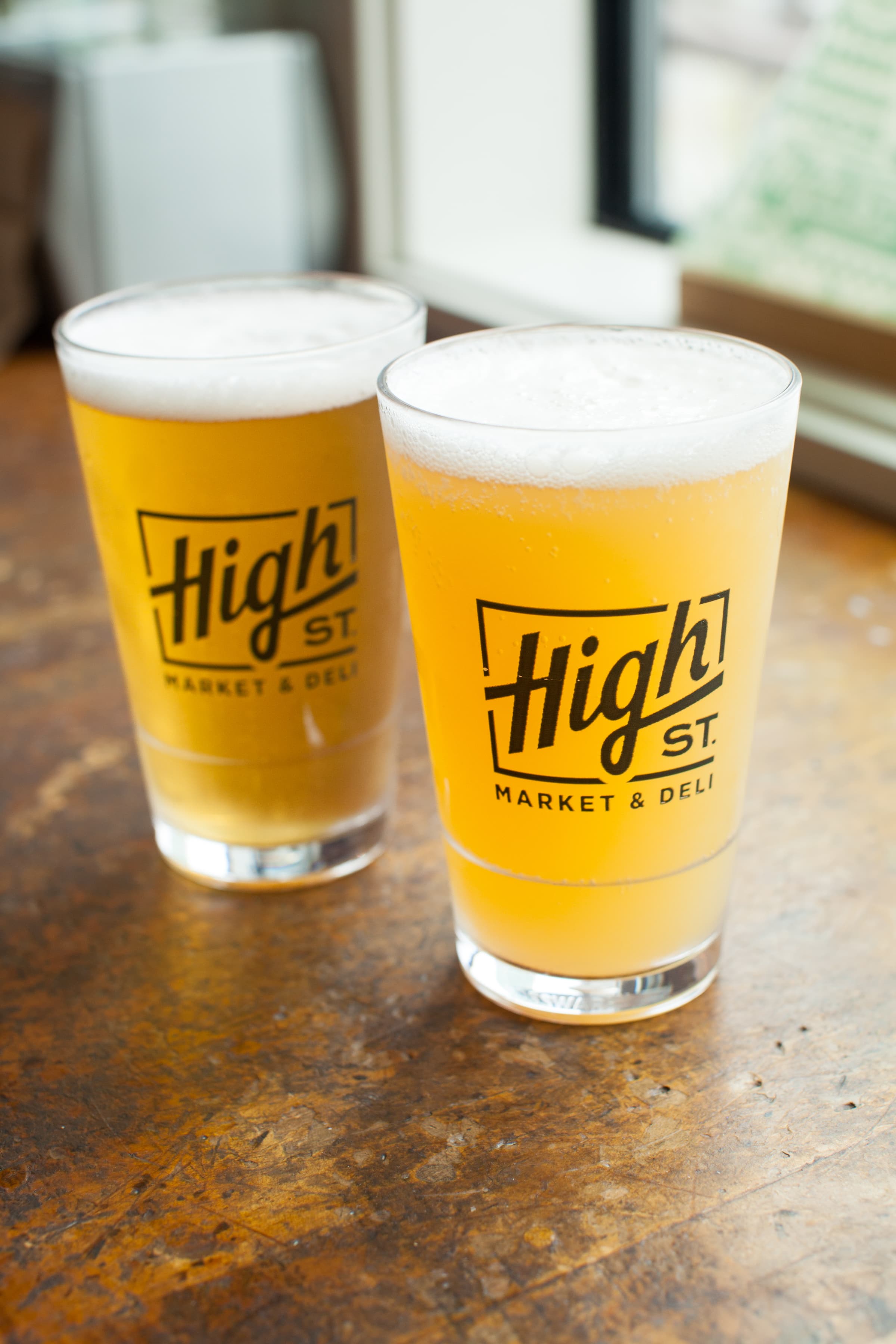 A tabletop mix of custom drinkware and branded goods arranged for a lifestyle product shot