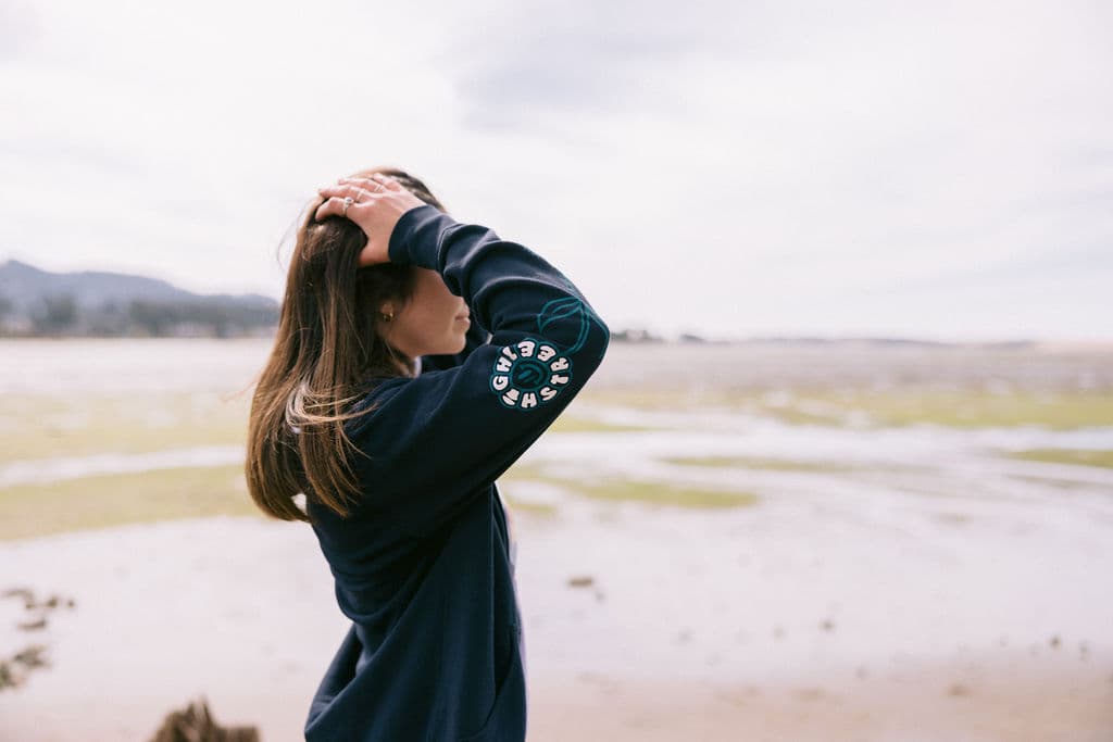 High St Deli hoodie photographed from the side with a sleeve print visible on the arm