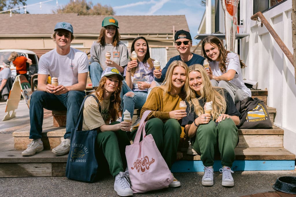 A group wearing branded goods made by Orange Goods