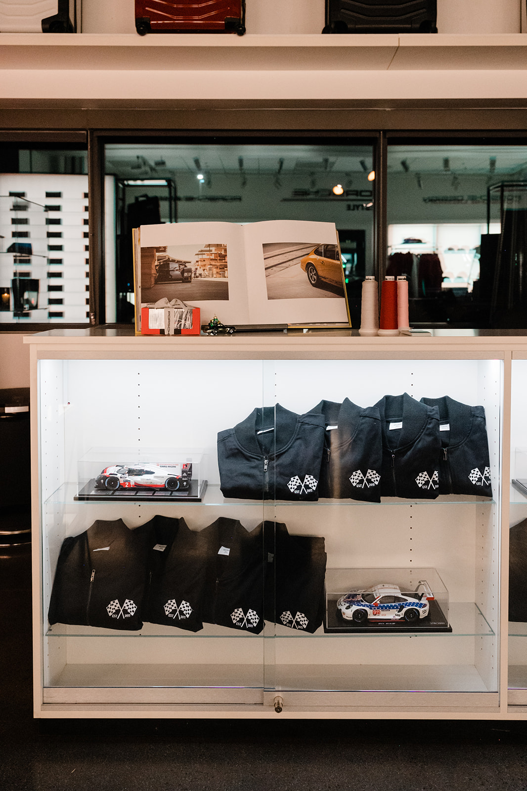 K1 x Porsche — Holiday Merch Display